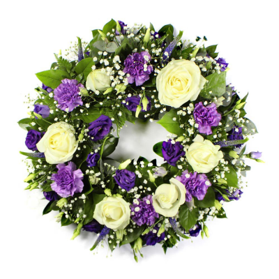 Wreath SYM-316 - A beautiful classic wreath arranged using purple and white flowers and finished with fine foliage.